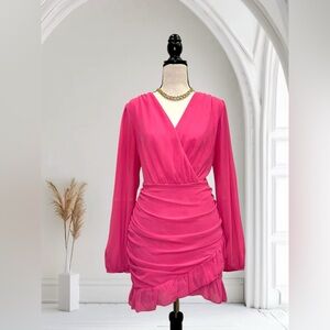 Long sleeve mini dress with a v-neckline, ruched skirt, and a ruffle hem.